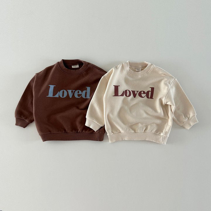 A soft, cozy baby outfit laid out with bodysuits, footed pajamas, mittens, hats, and gentle neutral colors, creating a sweet and welcoming nursery scene.