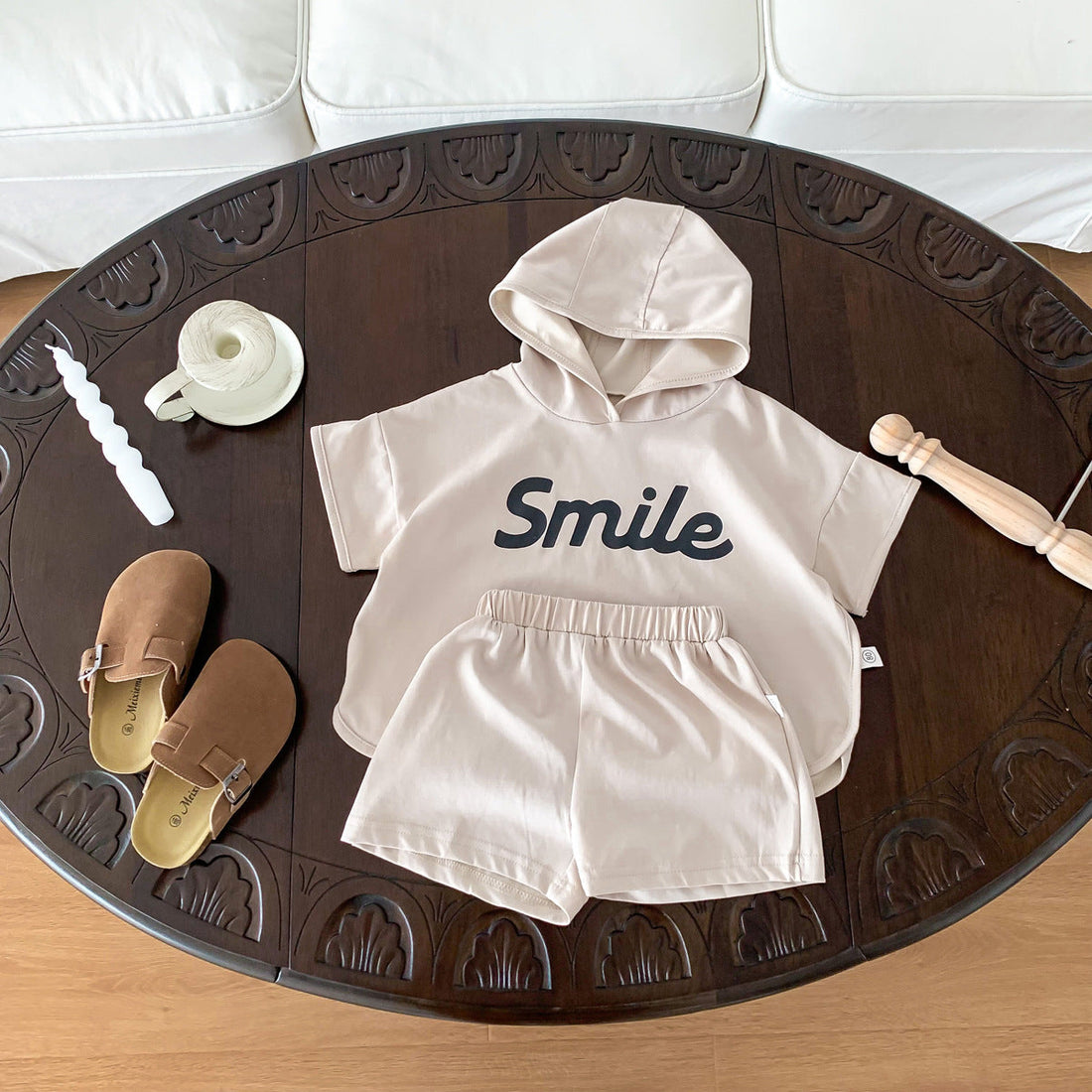 A smiling parent holding a baby while checking a modern baby monitor in a softly lit nursery, radiating warmth, comfort, and peace of mind.