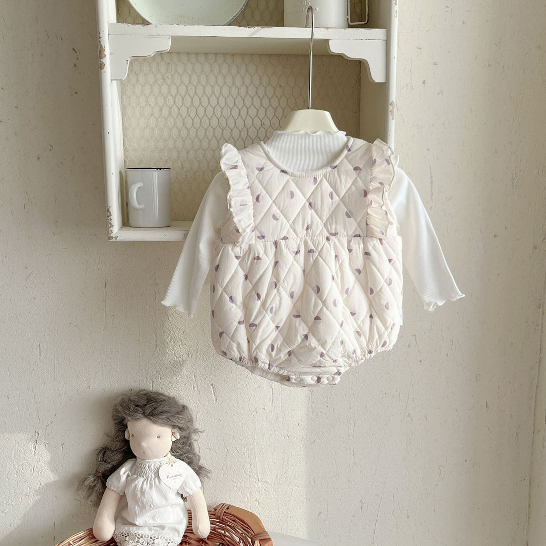 A smiling baby wrapped in a soft, pastel blanket, surrounded by gentle skincare products and plush toys, highlighting comfort for sensitive skin.