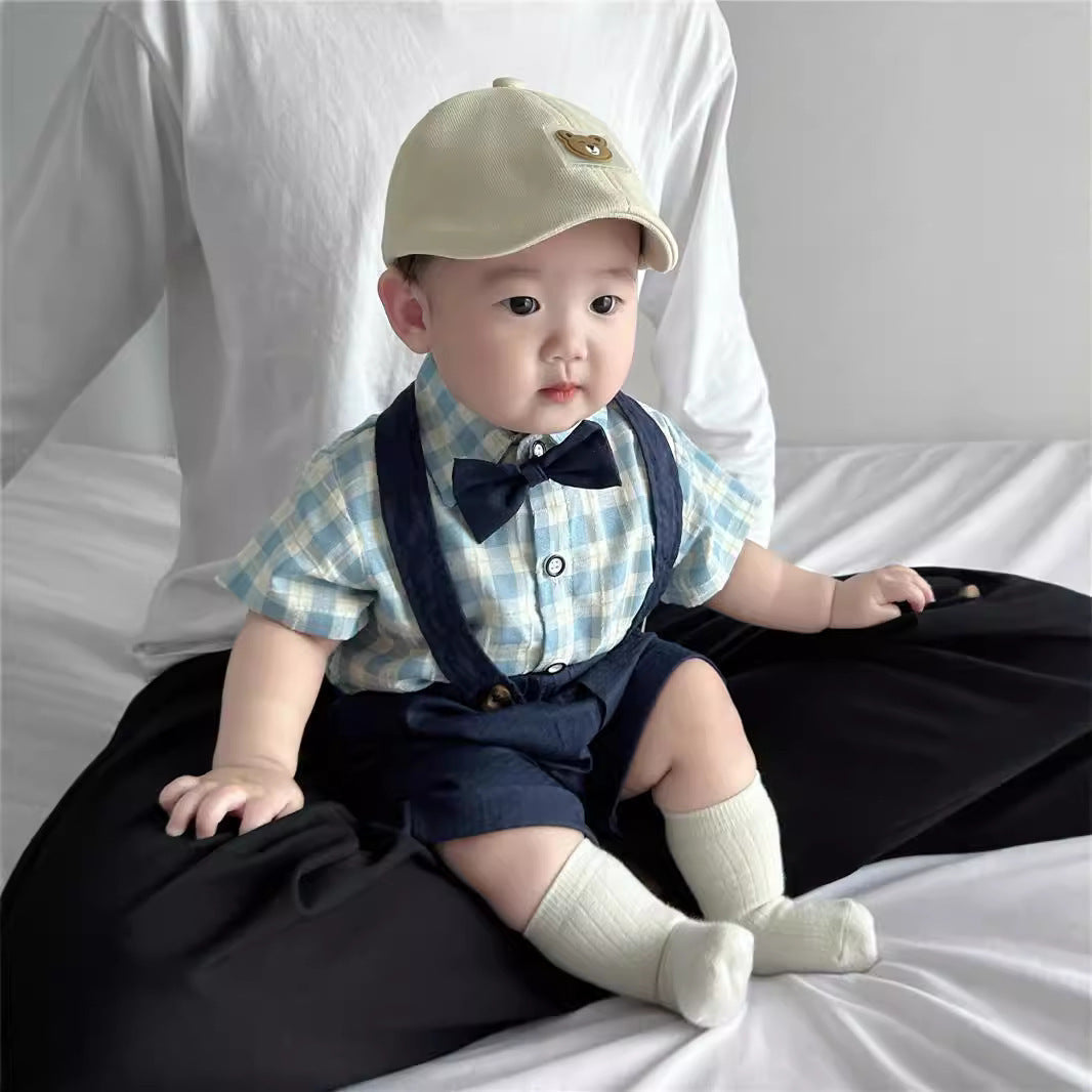 A smiling baby in a cozy outfit is gently fed with a small spoon, surrounded by soft toys and colorful baby essentials in a bright, nurturing space.