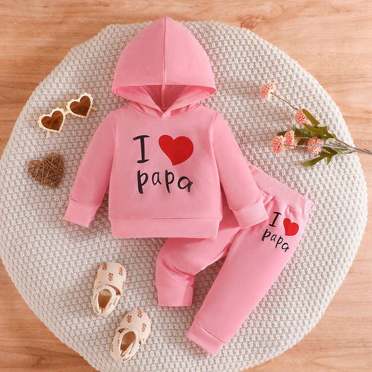 A smiling baby wearing a cozy onesie holds a teething toy, surrounded by soft blankets and gentle sunlight, highlighting teething comfort and care.