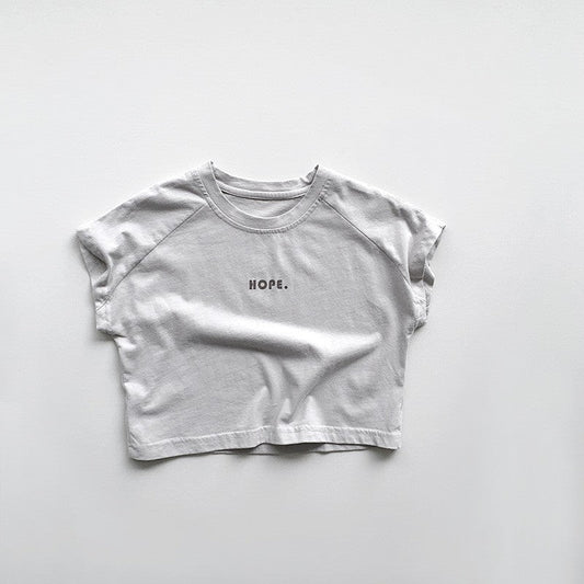 Smiling parent gently bottle-feeds calm baby in cozy nursery, highlighting peaceful feeding time and comfort, thanks to anti-colic bottle design.