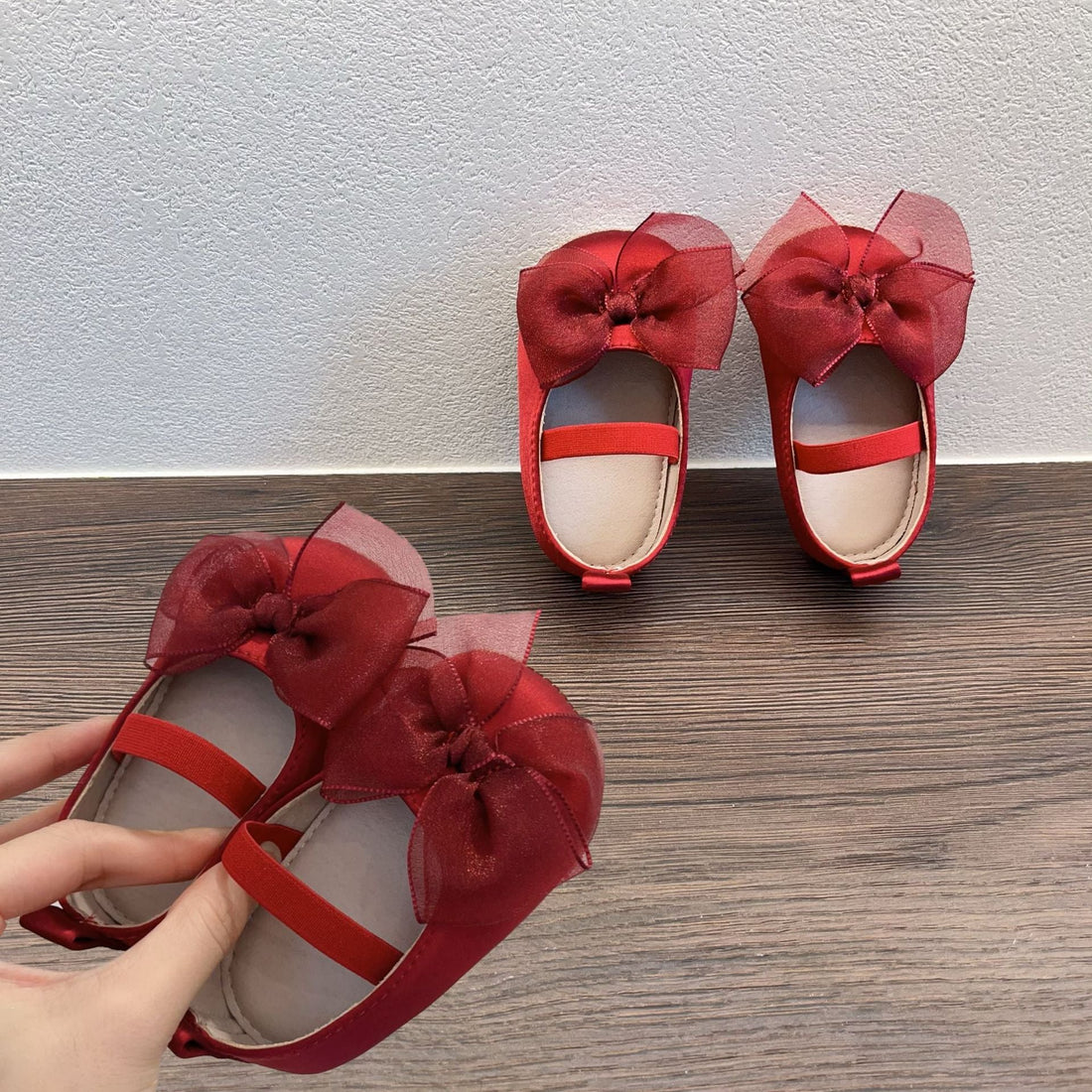 A cheerful mom and her baby browse soft baby clothes, cozy blankets, and playful toys in a warm, inviting boutique filled with joyful details.